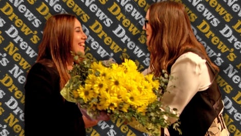 Drew presenting bouquet to nurse